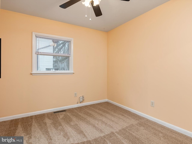 spare room featuring carpet floors and ceiling fan