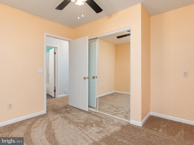 unfurnished bedroom featuring a closet, ceiling fan, and carpet flooring