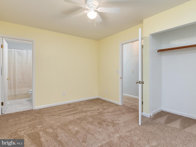 unfurnished bedroom featuring connected bathroom, light colored carpet, and ceiling fan