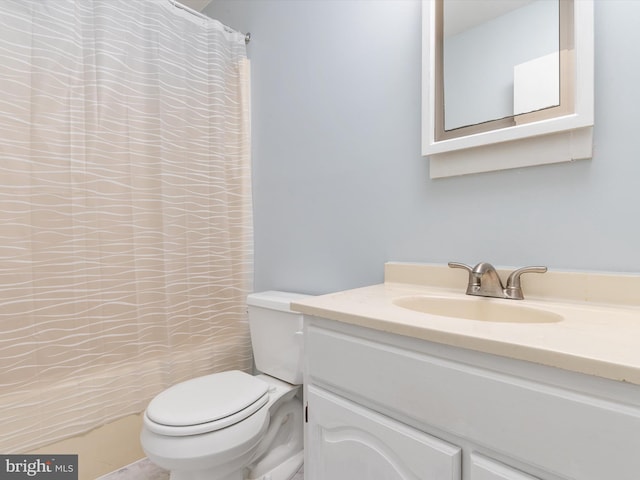 bathroom with vanity, a shower with curtain, and toilet