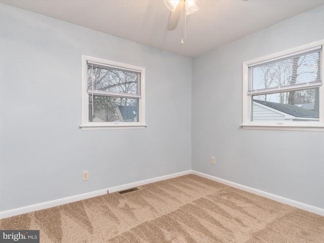 carpeted empty room with ceiling fan