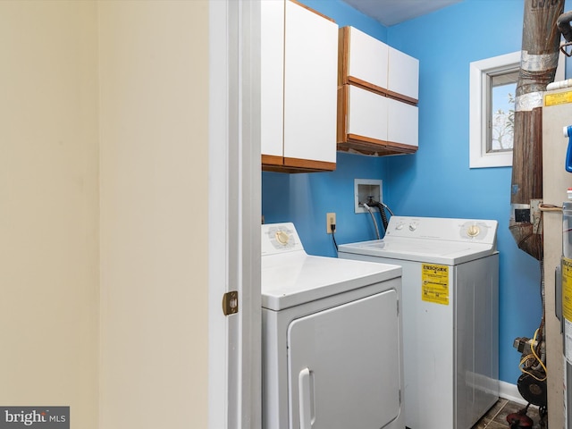 laundry room featuring cabinets and washing machine and clothes dryer