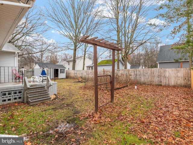 view of yard featuring a storage shed and a deck