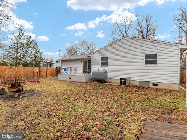 rear view of property featuring a deck