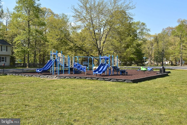 view of playground with a lawn