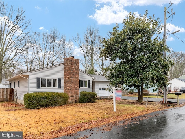 view of side of home featuring a garage