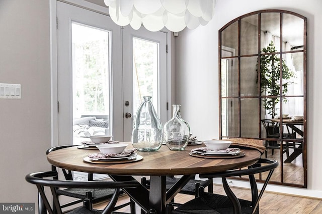 dining room with french doors and hardwood / wood-style floors