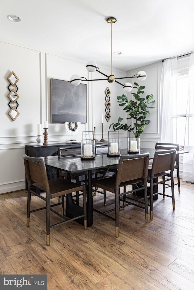 dining space with hardwood / wood-style flooring