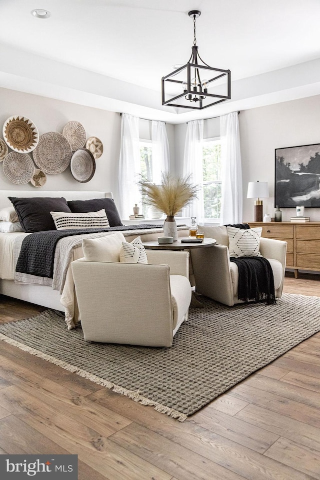 bedroom with an inviting chandelier and wood-type flooring