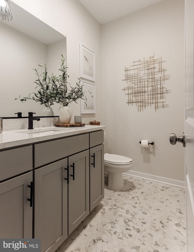 bathroom with vanity, tile patterned flooring, and toilet