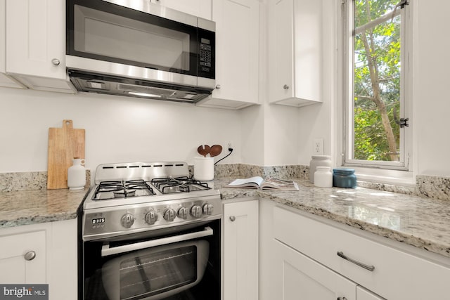 1727 Massachusetts Ave NW Unit 307, Washington, DC 20036 - kitchen with white cabinetry, appliances with stainless steel finishes, and light stone countertops