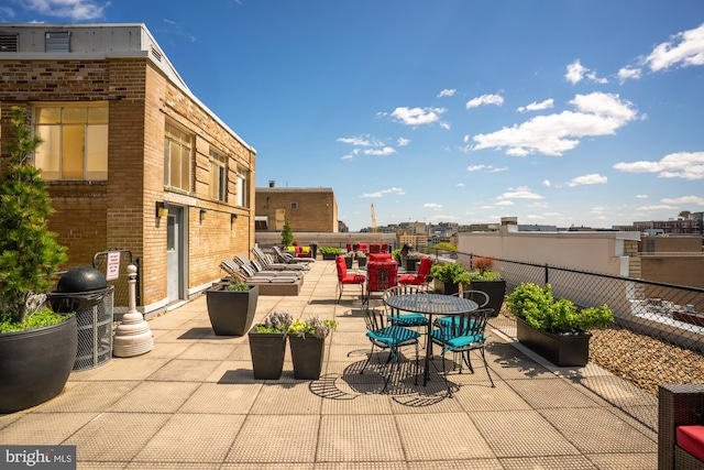 1727 Massachusetts Ave NW Unit 307, Washington, DC 20036 - view of patio featuring grilling area, outdoor dining space, and fence