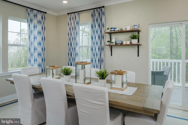 dining space featuring crown molding and a wealth of natural light