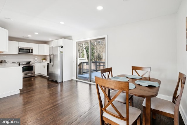 dining area with dark hardwood / wood-style floors