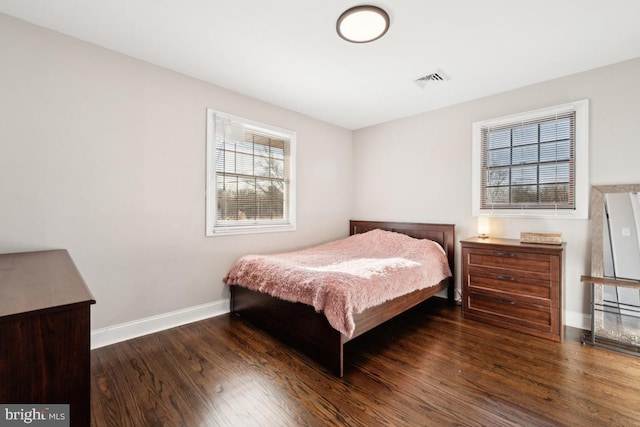 bedroom with dark hardwood / wood-style floors