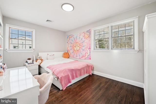 bedroom with dark hardwood / wood-style flooring