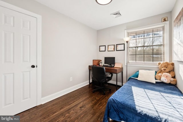 bedroom featuring dark hardwood / wood-style flooring