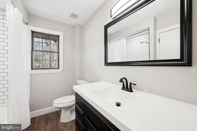 bathroom featuring vanity, hardwood / wood-style floors, toilet, and walk in shower