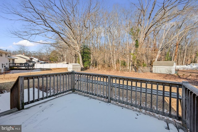 deck with a storage shed and a patio area