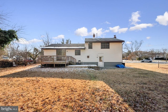 back of house with a lawn and a deck