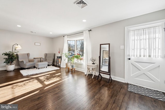 sitting room with dark wood-type flooring