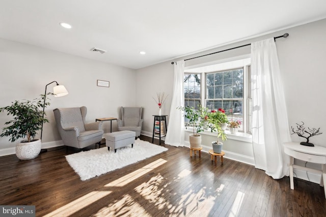 sitting room featuring dark wood-type flooring