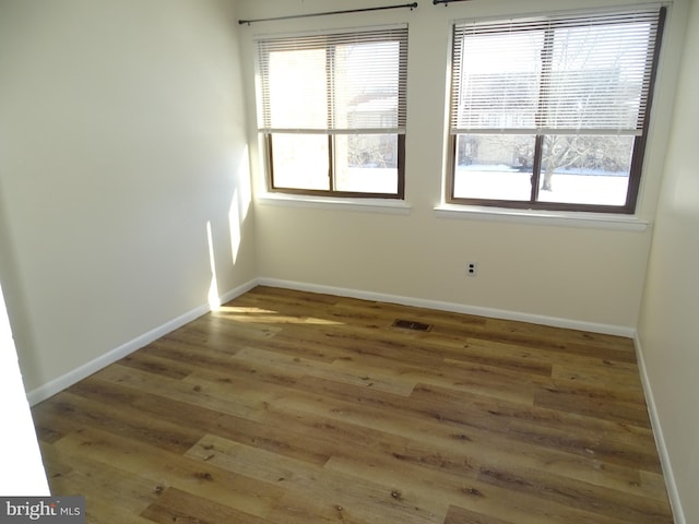 spare room with dark hardwood / wood-style flooring