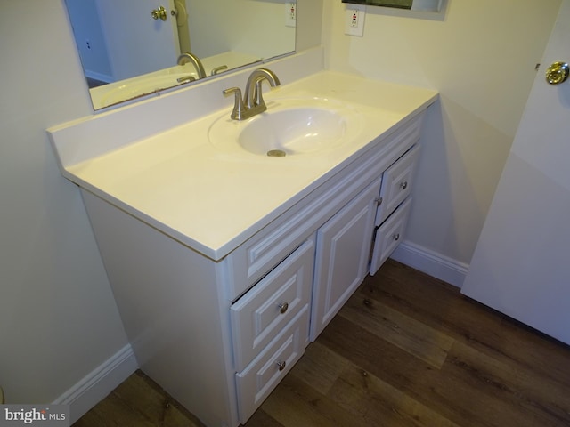 bathroom featuring hardwood / wood-style flooring and vanity