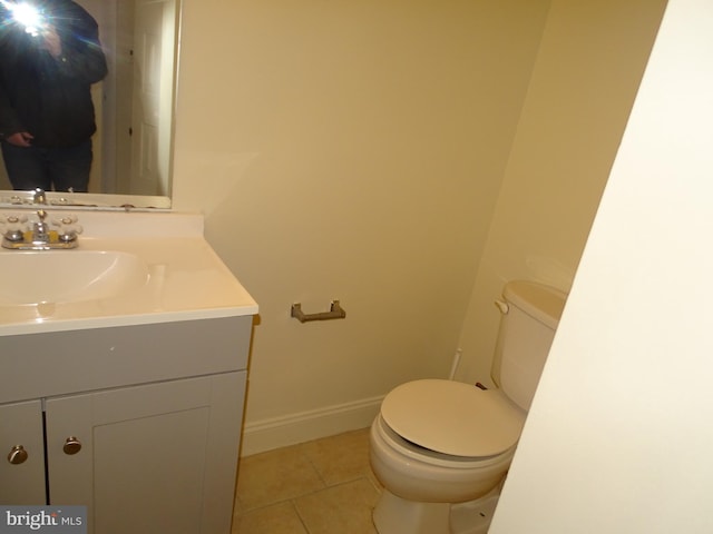 bathroom with vanity, toilet, and tile patterned flooring