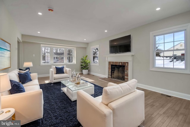 living room with wood-type flooring and a fireplace