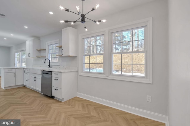 kitchen featuring dishwasher, plenty of natural light, sink, and white cabinets