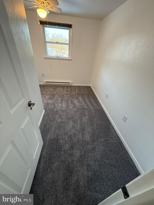 carpeted spare room with a baseboard heating unit and ceiling fan