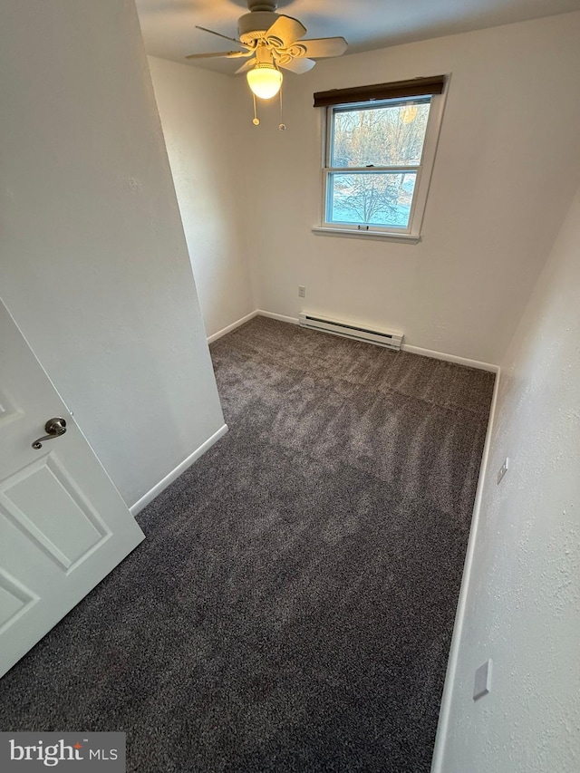 spare room featuring a baseboard heating unit, carpet floors, and ceiling fan