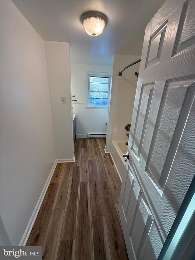 hall with hardwood / wood-style flooring and baseboard heating