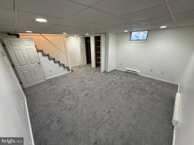 basement featuring a baseboard radiator and carpet