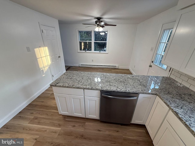 kitchen with baseboard heating, hardwood / wood-style floors, light stone counters, white cabinets, and stainless steel dishwasher