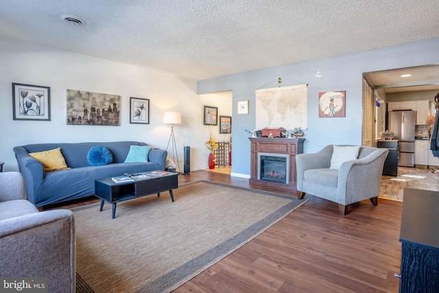 living room featuring hardwood / wood-style floors and a textured ceiling