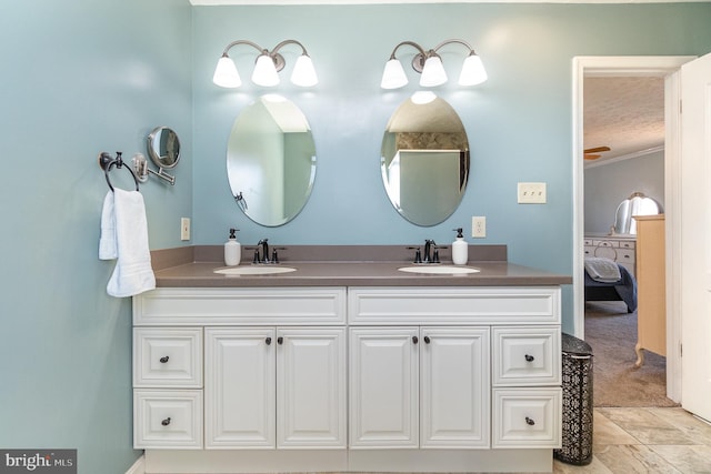 bathroom featuring vanity, crown molding, and a textured ceiling