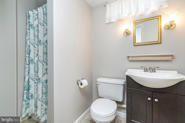 bathroom featuring vanity, curtained shower, and toilet