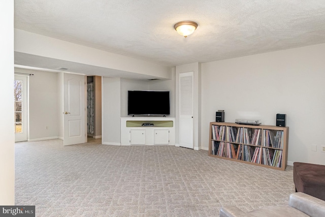 carpeted living room featuring a textured ceiling