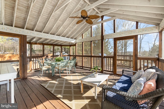 sunroom / solarium featuring ceiling fan and vaulted ceiling with beams