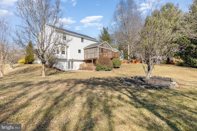 exterior space with a yard and a sunroom