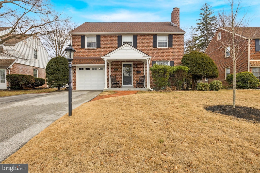 view of front of property with a garage and a front yard