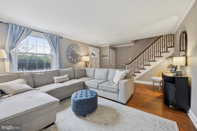 living room with hardwood / wood-style floors and crown molding