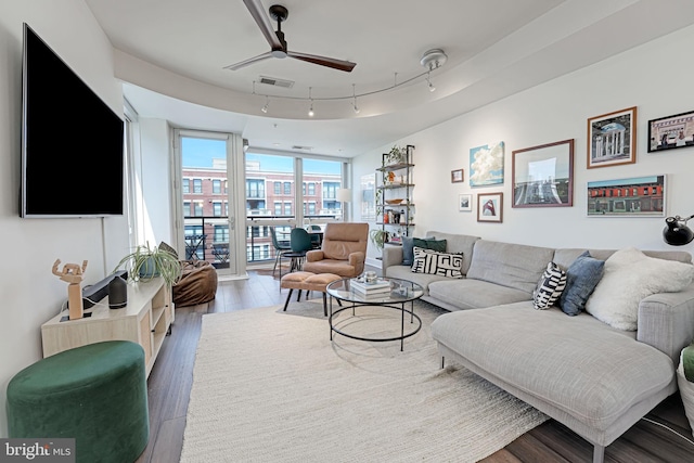 living room featuring hardwood / wood-style floors, a wall of windows, ceiling fan, and track lighting