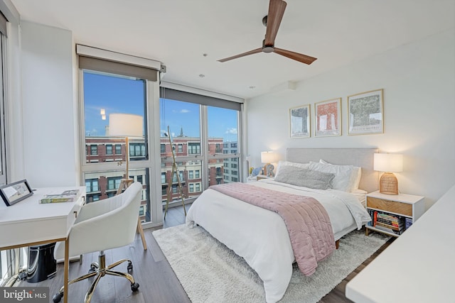 bedroom with ceiling fan, floor to ceiling windows, and hardwood / wood-style floors