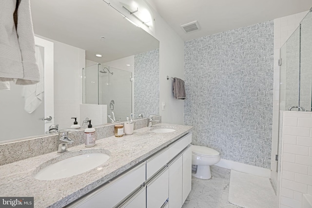 bathroom with vanity, a shower with shower door, and toilet