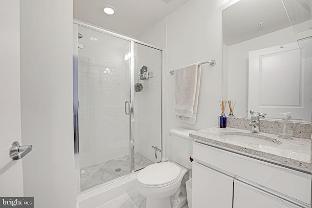 bathroom with vanity, an enclosed shower, and toilet