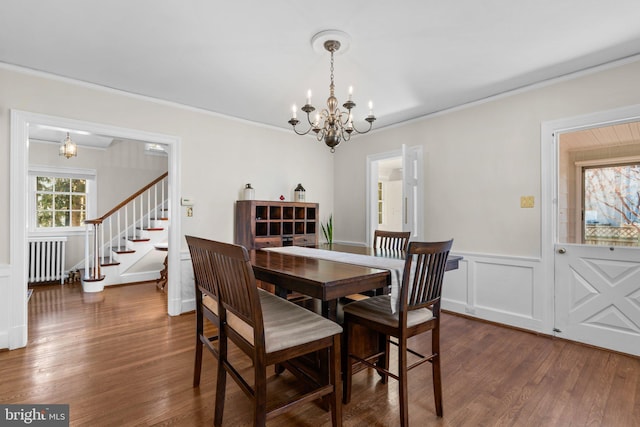 dining space with a chandelier, stairs, ornamental molding, radiator, and dark wood-style floors