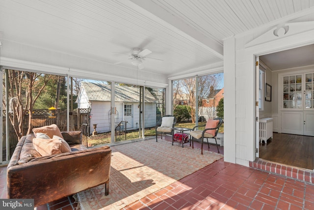 sunroom / solarium featuring ceiling fan